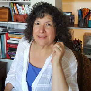 Headshot of Lifetime Arts Trainer, Antonia Perez. She has dark shoulder length hair and dark eyes. She is smiling.