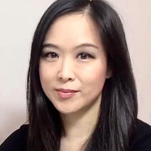 Headshot of Lifetime Arts Trainer, Jade Lam. She has dark long hair and dark eyes. She is smiling.