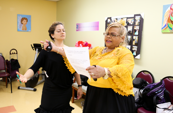 A teaching artist works with a flamenco student.